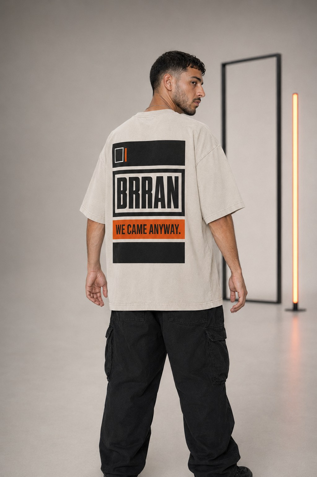 ENTRY 02 bone oversized T-shirt, back view, access-pass graphic with WE CAME ANYWAY strip