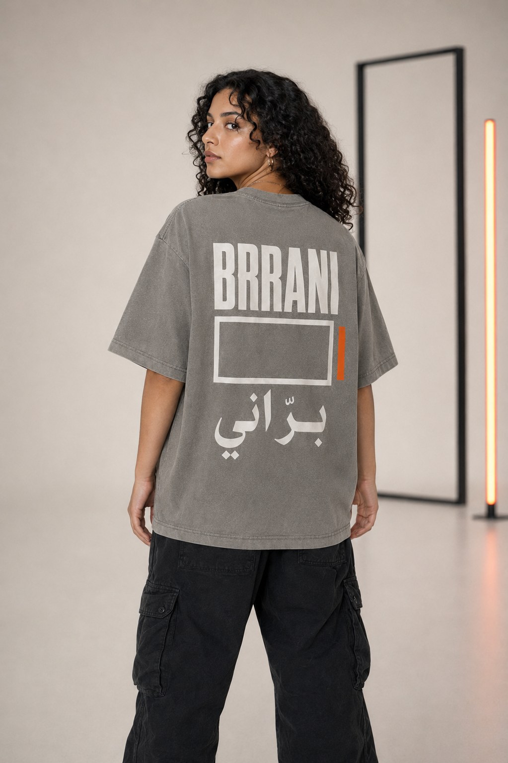 LOCAL 03 concrete gray oversized T-shirt, back view, BRRANI open frame and Arabic signature